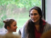 Kristin smiling while teaching a young violin student